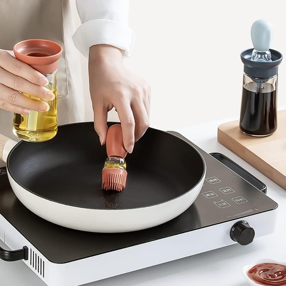 Oil dispenser with brush from Dealscartt, clear glass container with attached brush for precise oil application.