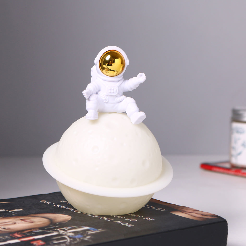 Astronaut Saturn night light lamp by Dealscartt, featuring a detailed astronaut figure holding a glowing Saturn planet.