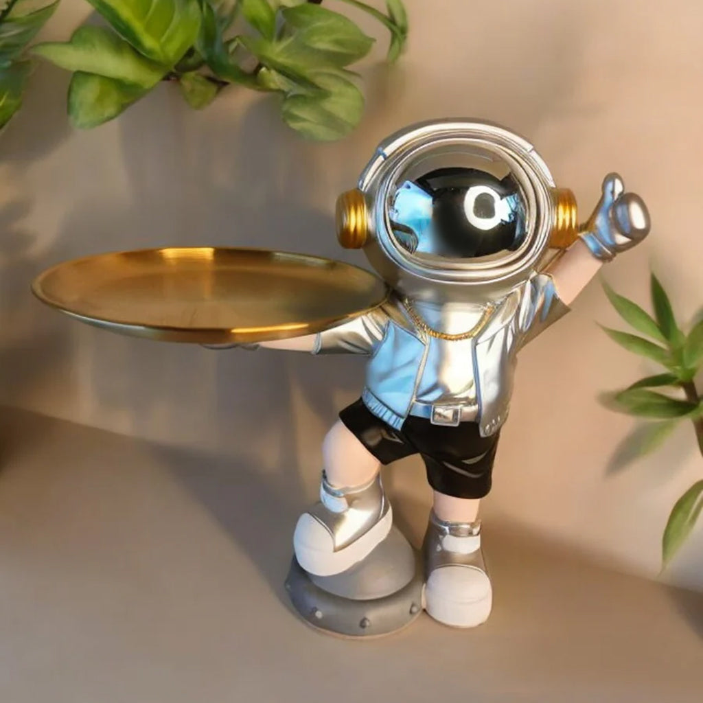 Silver astronaut serve showpiece for home decor, featuring a modern astronaut design in a sleek silver finish.