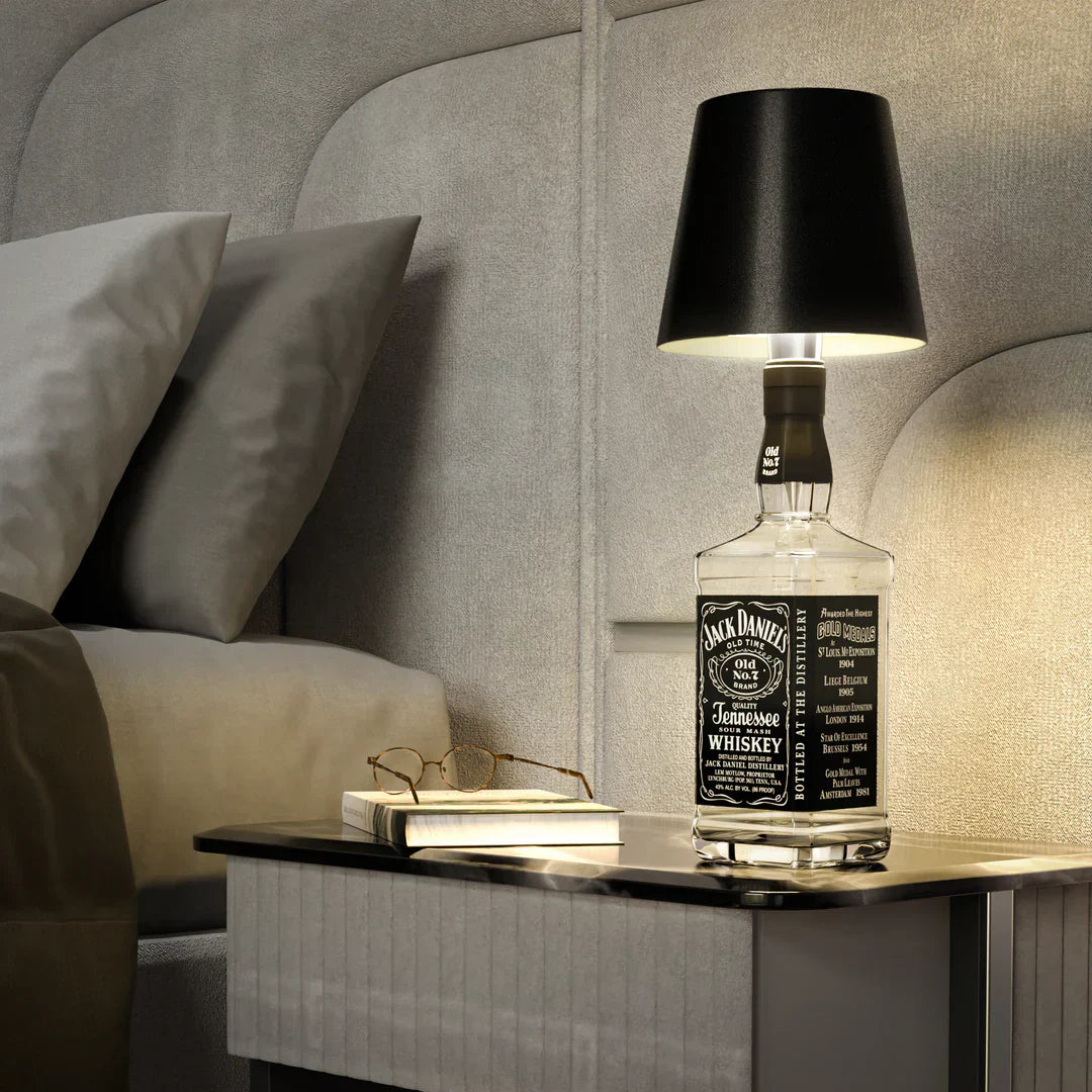Eclectic Essentials AuraLite Wireless Bottle Lamp glowing with a soft light, rechargeable and portable for ambient lighting.