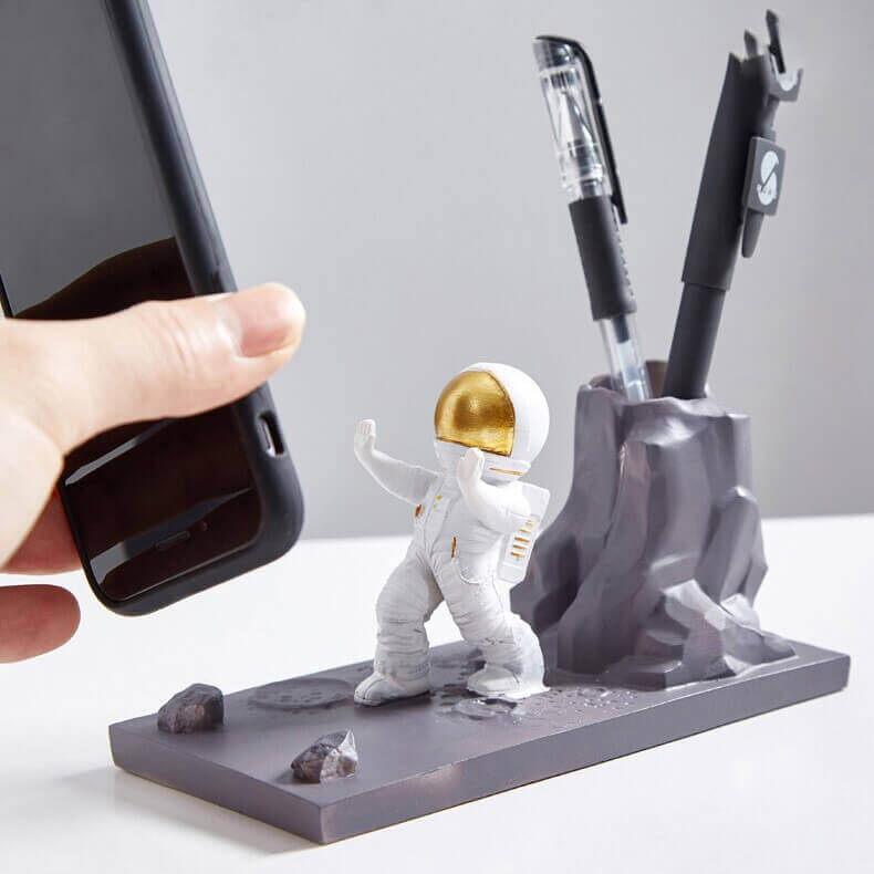 Astro Stationery and Phone Holder by Dealscartt, black phone stand holding a smartphone with stationery accessories.