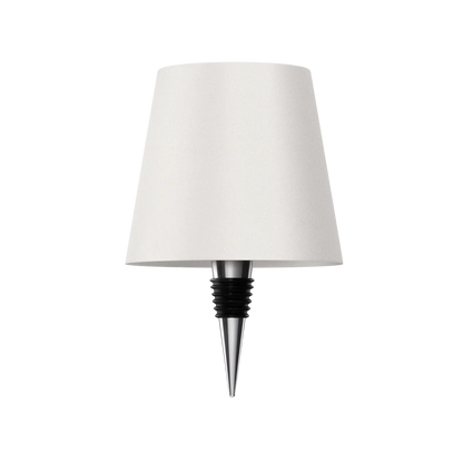 Eclectic Essentials AuraLite wireless rechargeable bottle lamp in transparent white, illuminated and glowing in a stylish setting.