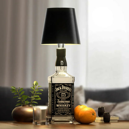 Empty AuraLite wireless rechargeable bottle lamp by Eclectic Essentials, showcasing sleek design and smooth surface.