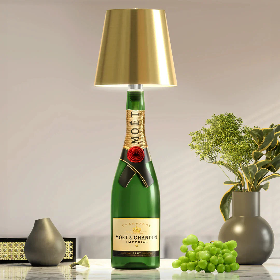 Gold AuraLite Wireless Rechargeable Bottle Lamp by Eclectic Essentials displayed empty, highlighting its sleek design and modern style.