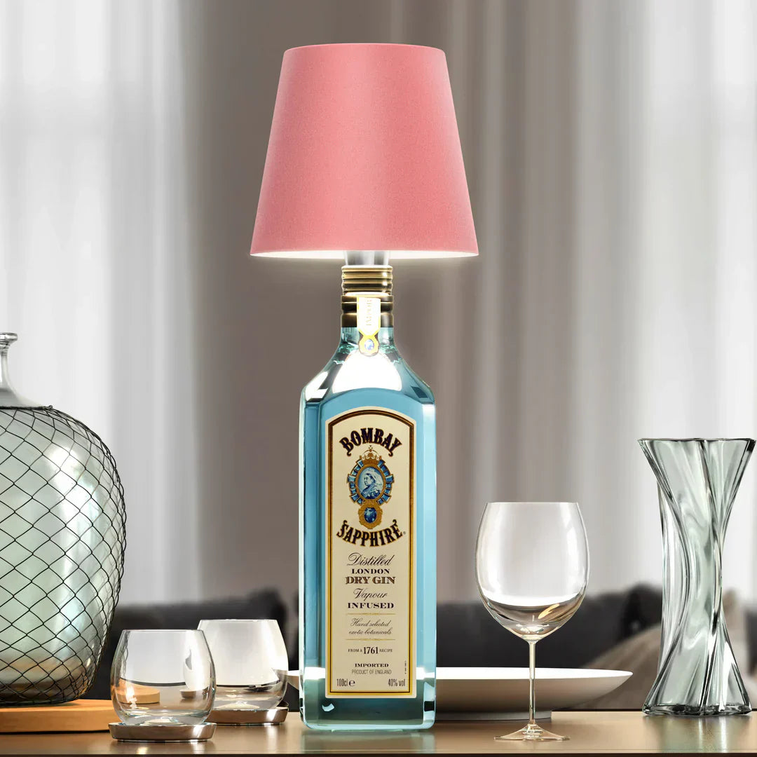 Eclectic Essentials AuraLite wireless rechargeable bottle lamp in pink, empty, showcasing its sleek, modern design and soft glow.