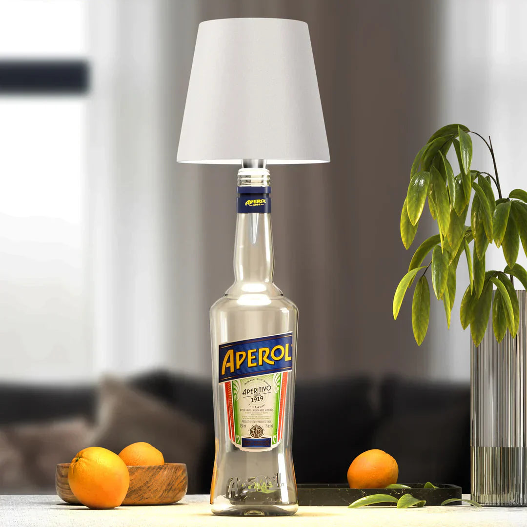 Eclectic Essentials AuraLite wireless bottle lamp glowing white, rechargeable LED light inside an empty glass bottle for ambient lighting