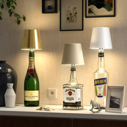 Eclectic Essentials AuraLite wireless rechargeable bottle lamp glowing with soft ambient light on a dark background.